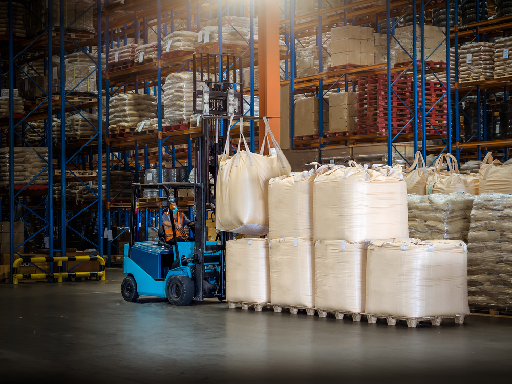 Forklift,Is,Handling,Jumbo,Bags,In,Large,Warehouse.